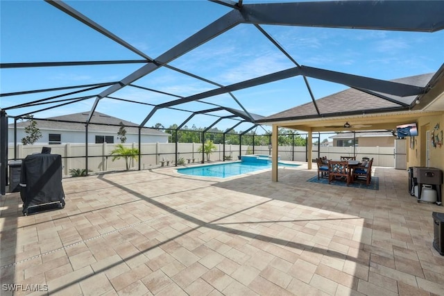 view of swimming pool with a lanai, a fenced backyard, outdoor dining area, and a patio