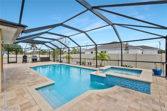 view of swimming pool featuring a patio, a pool with connected hot tub, a fenced backyard, and glass enclosure