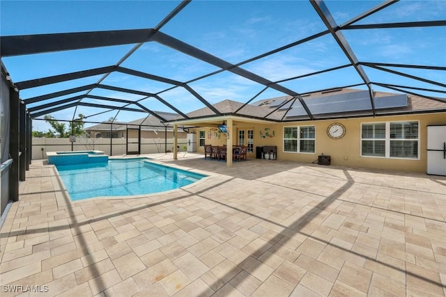 view of pool with a pool with connected hot tub, a patio area, french doors, and a lanai