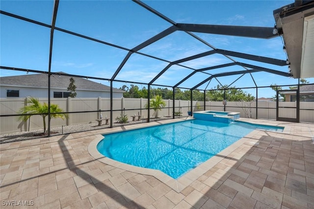 view of pool with glass enclosure, a pool with connected hot tub, fence, and a patio