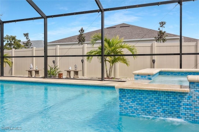 view of swimming pool featuring fence, a fenced in pool, and a lanai