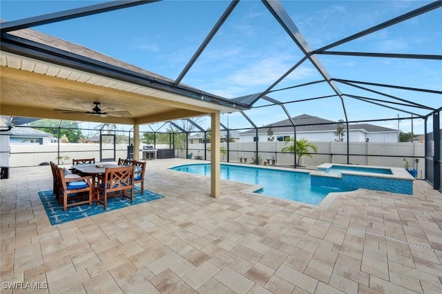 view of pool featuring a pool with connected hot tub, glass enclosure, a patio area, fence, and ceiling fan