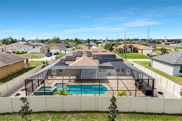 view of pool with a patio, a fenced backyard, a residential view, and a lanai