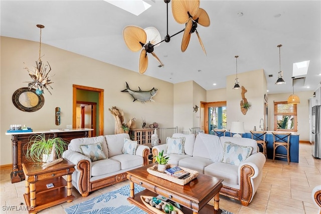 living area with recessed lighting, baseboards, a skylight, and a ceiling fan