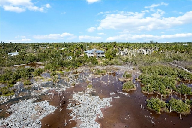 drone / aerial view featuring a forest view