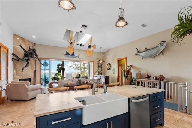 kitchen with blue cabinetry, visible vents, stainless steel dishwasher, and open floor plan