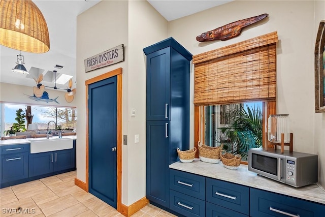 mudroom with a sink, baseboards, and light tile patterned floors