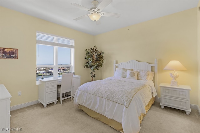 bedroom with baseboards, ceiling fan, and light colored carpet