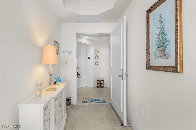 hallway featuring visible vents and light tile patterned flooring