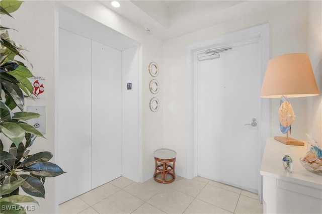 hall featuring light tile patterned floors