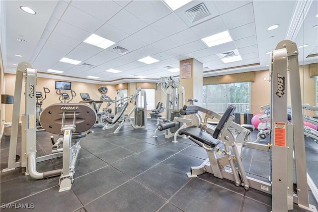 gym with a paneled ceiling and visible vents