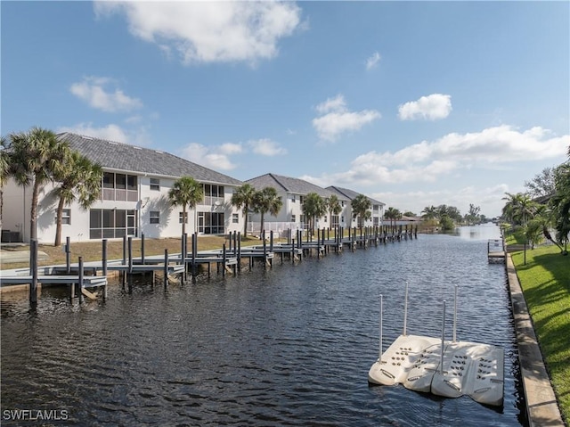 view of dock with a residential view, a water view, and boat lift