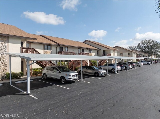 covered parking lot featuring a residential view