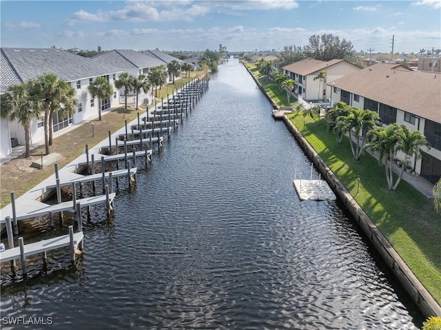 719 SW 47th Ter Unit 101, Cape Coral, FL 33914 - water view with boat lift, a boat dock, and nearby suburban area