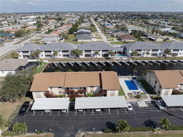 bird's eye view featuring a water view and a residential view