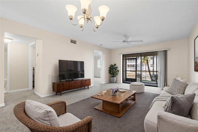 carpeted living area featuring visible vents, baseboards, and ceiling fan with notable chandelier