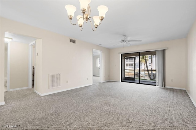 carpeted spare room with visible vents, baseboards, and ceiling fan with notable chandelier