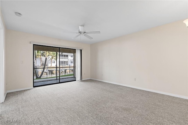 unfurnished room with carpet, ceiling fan, and baseboards