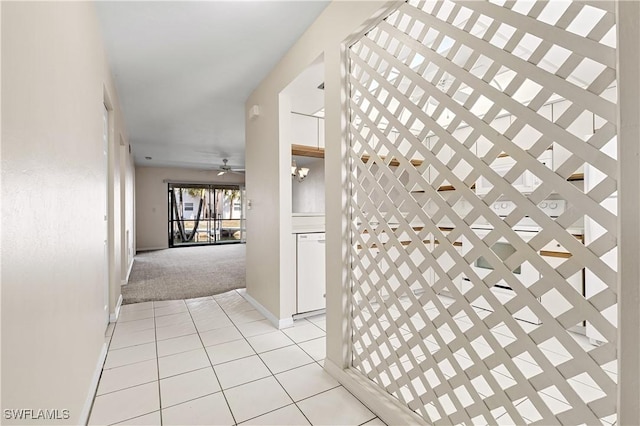 corridor with light carpet and light tile patterned flooring