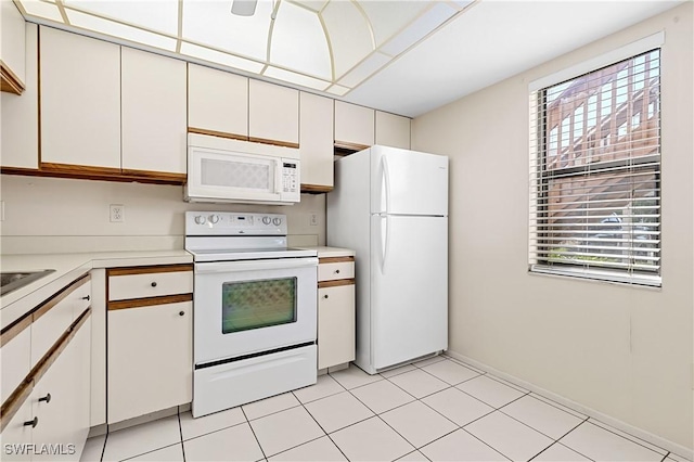 719 SW 47th Ter Unit 101, Cape Coral, FL 33914 - kitchen with white appliances, light countertops, plenty of natural light, and white cabinets