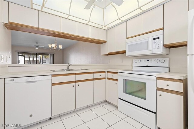 kitchen featuring white appliances, light tile patterned floors, a ceiling fan, light countertops, and a sink