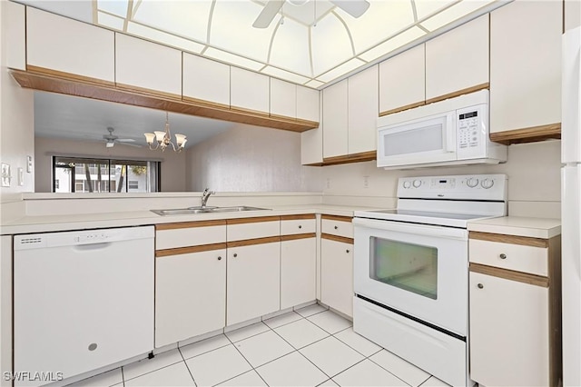 719 SW 47th Ter Unit 101, Cape Coral, FL 33914 - kitchen with white appliances, a sink, ceiling fan, light countertops, and light tile patterned floors