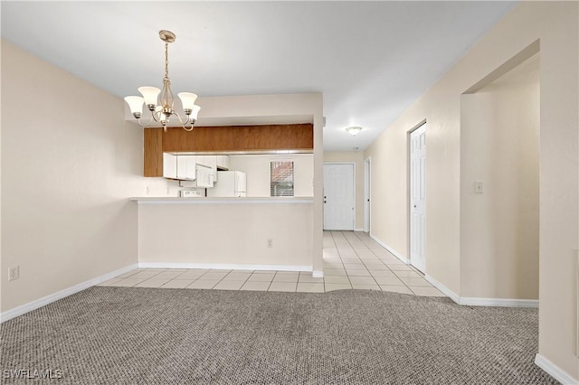 kitchen with light carpet, light tile patterned floors, freestanding refrigerator, and a notable chandelier