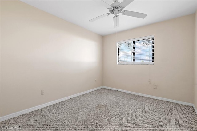 carpeted empty room with a ceiling fan and baseboards