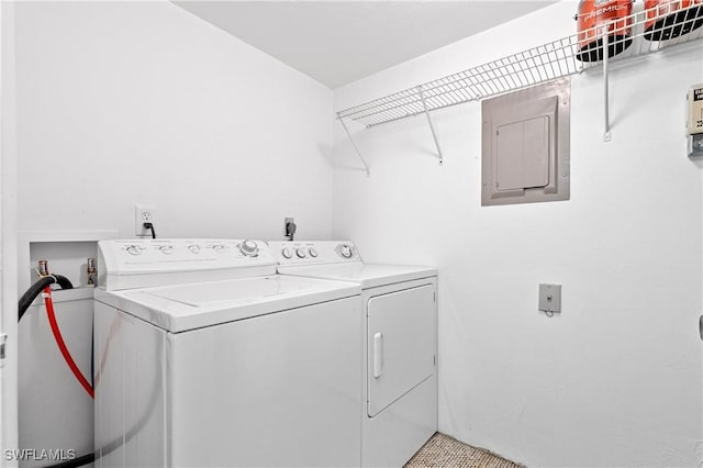 laundry area featuring laundry area, washing machine and dryer, and electric panel