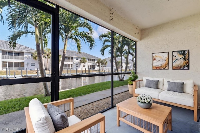 sunroom / solarium with a residential view and a water view