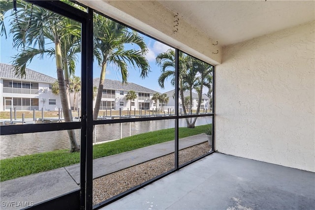 719 SW 47th Ter Unit 101, Cape Coral, FL 33914 - unfurnished sunroom with a water view and a residential view
