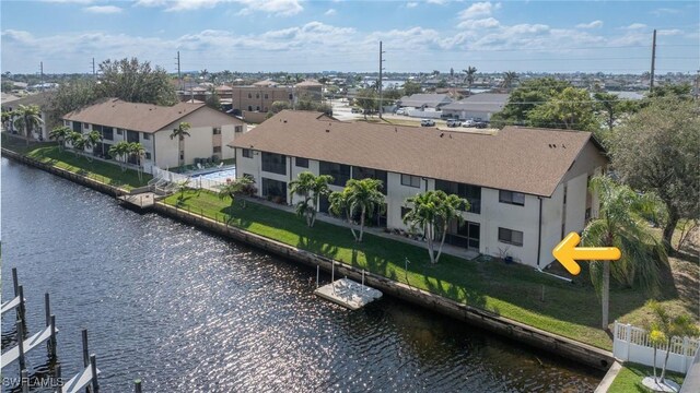 birds eye view of property featuring a water view and a residential view