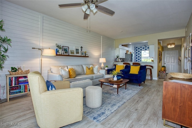 living area featuring a ceiling fan and light wood-style flooring