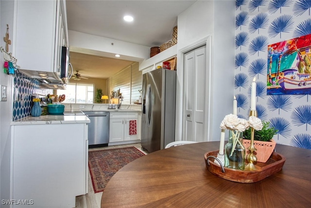 kitchen featuring recessed lighting, light countertops, appliances with stainless steel finishes, a ceiling fan, and white cabinetry