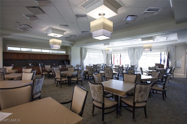 dining space with ornamental molding, carpet, visible vents, and a tray ceiling