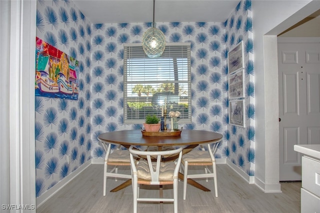 8106 Queen Palm Ln Unit 115, Fort Myers, FL 33966 - dining space with wallpapered walls, baseboards, and light wood-type flooring