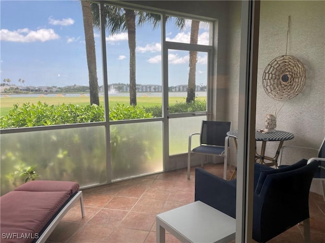 8106 Queen Palm Ln Unit 115, Fort Myers, FL 33966 - sunroom featuring a water view and a textured wall