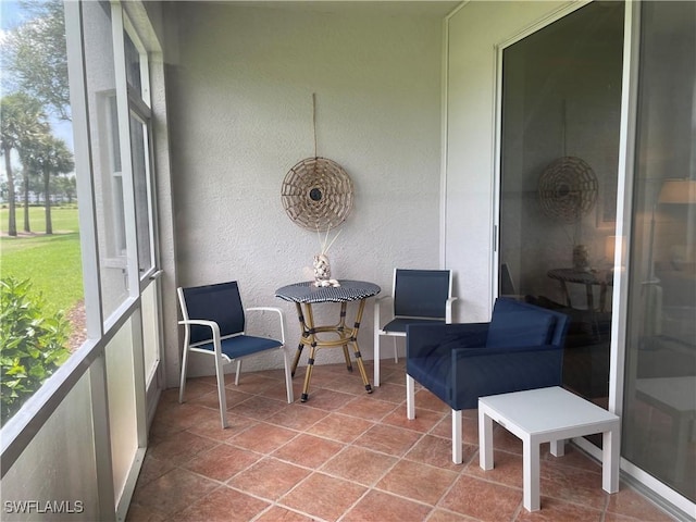 8106 Queen Palm Ln Unit 115, Fort Myers, FL 33966 - sunroom featuring a textured wall