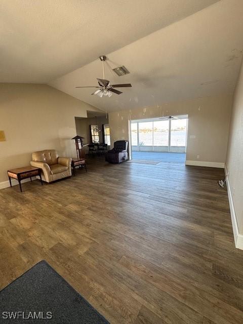 unfurnished living room featuring visible vents, vaulted ceiling, baseboards, and wood finished floors