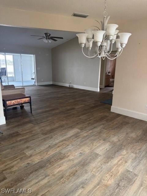 living area featuring dark wood-style flooring, visible vents, baseboards, and ceiling fan with notable chandelier