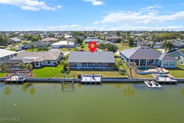 birds eye view of property featuring a residential view and a water view