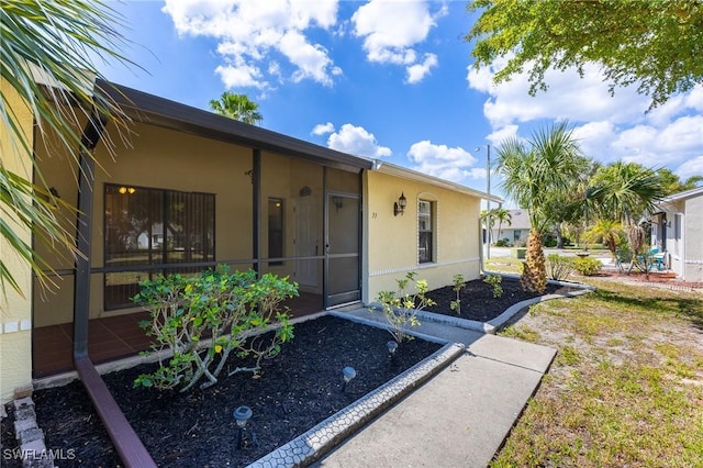 view of side of property with stucco siding