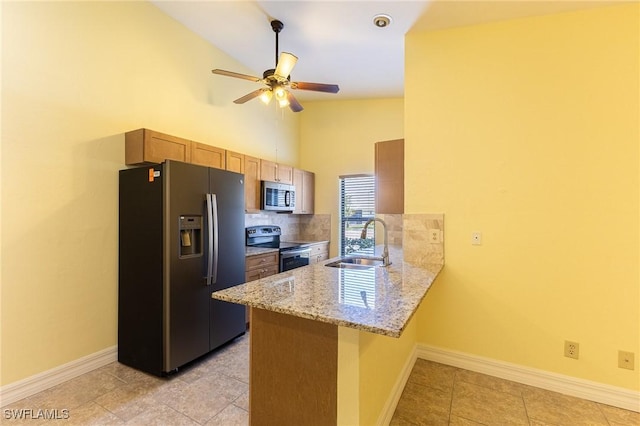 kitchen with baseboards, decorative backsplash, a peninsula, stainless steel appliances, and a sink