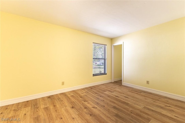 unfurnished room featuring light wood-style floors and baseboards