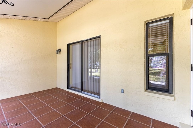 doorway to property with a patio area and stucco siding