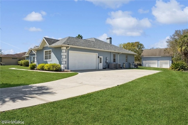 single story home featuring a garage, driveway, a chimney, and a front lawn