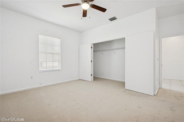 unfurnished bedroom featuring a closet, a ceiling fan, visible vents, baseboards, and carpet floors