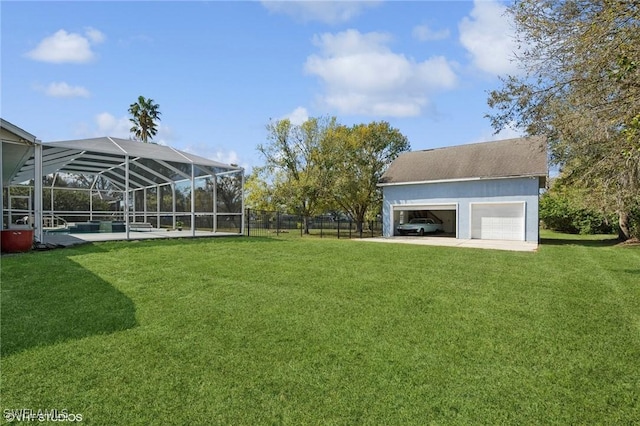 view of yard featuring fence, an outdoor structure, a detached garage, and a pool
