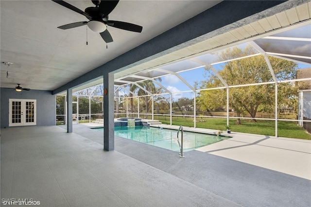 view of pool with glass enclosure, a pool with connected hot tub, a patio area, french doors, and a ceiling fan