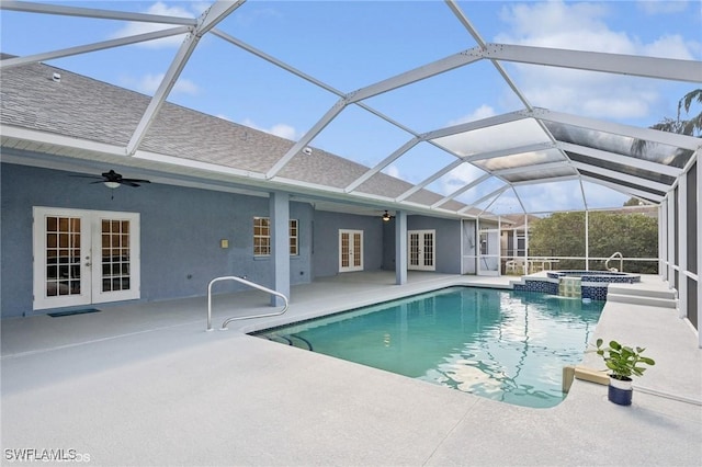 view of swimming pool with a ceiling fan, a patio area, french doors, and a pool with connected hot tub